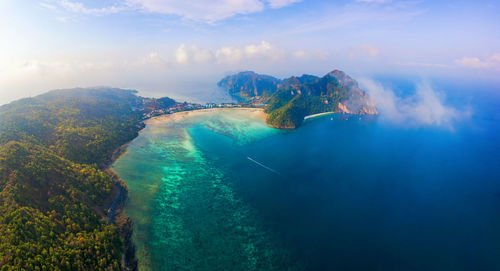 Panoramic view of sea and mountains against sky