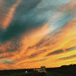 Scenic view of landscape against cloudy sky