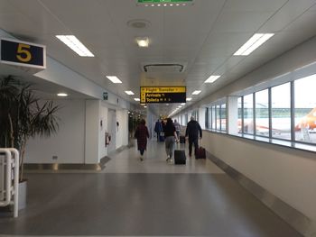 People walking in corridor of airport