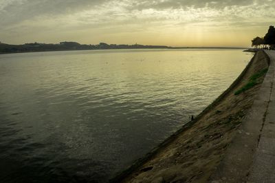 Scenic view of lake against sky at sunset