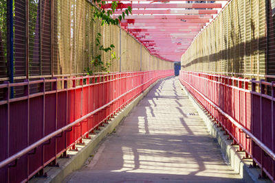 Empty footbridge along buildings