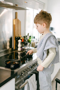 Boy preparing food in kitchen