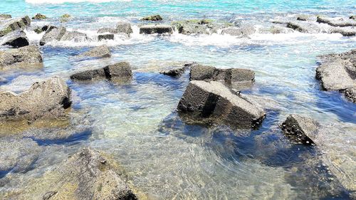 High angle view of waves splashing on rocks