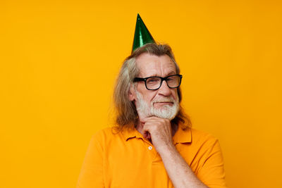 Young man against yellow background