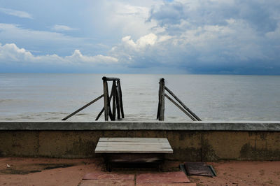 Lifeguard hut on beach against sky