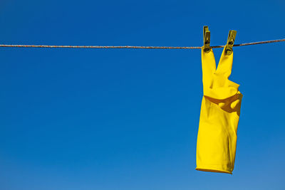 Low angle view of security camera against blue sky