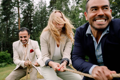 Happy friends sitting at park