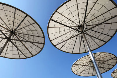 Umbrellas against blue sky 