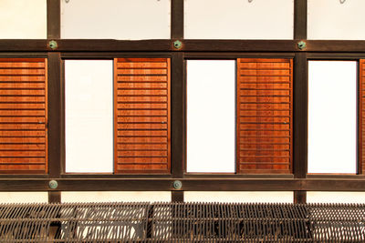 Full frame shot of traditional japanese building focused on sliding wooden windows