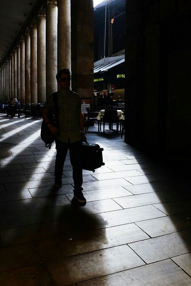 full length, walking, rear view, architecture, built structure, lifestyles, men, building exterior, street, city, city life, night, person, the way forward, leisure activity, illuminated, sidewalk, casual clothing