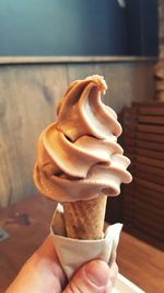 Close-up of hand holding ice cream cone