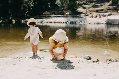 Brother and sister playing in the river