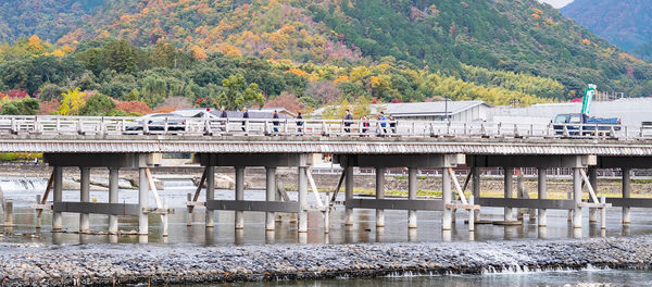 Train by river against mountain