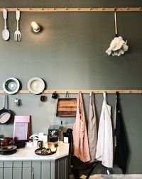 Clothes hanging on rack by table at home