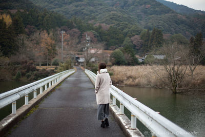 Rear view of woman on bridge