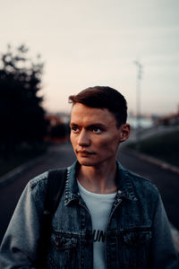 Portrait of young man standing against sky