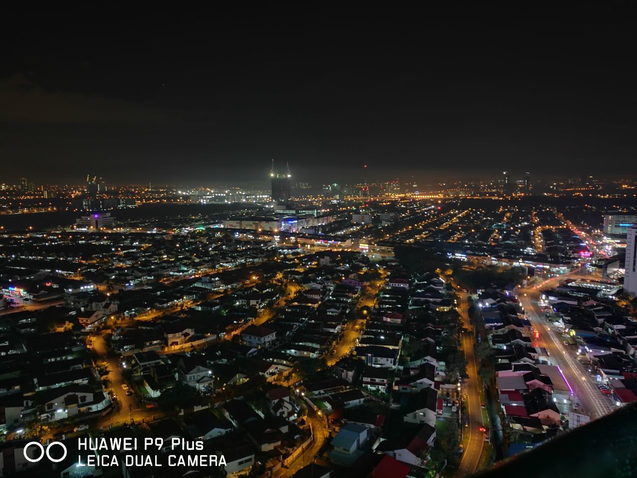 AERIAL VIEW OF ILLUMINATED CITY AT NIGHT