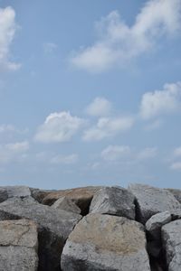 Low angle view of rocks against sky