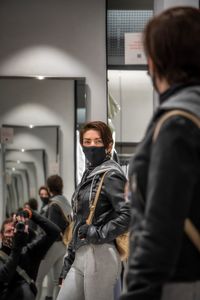 Rear view of people standing in bus