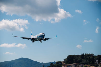 Low angle view of airplane flying against sky