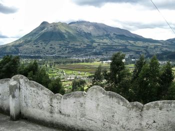 Scenic view of mountains against cloudy sky