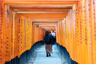 Full length rear view of man walking towards temple