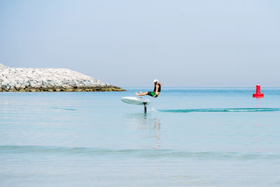 Man doing e foiling and falling