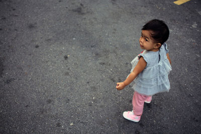 High angle view of girl standing on road