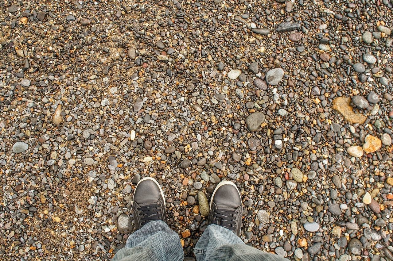 low section, person, shoe, personal perspective, standing, human foot, footwear, high angle view, lifestyles, leisure activity, men, directly above, jeans, unrecognizable person, leaf, outdoors, day