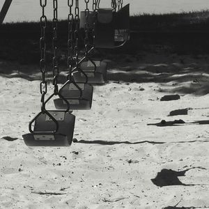 Swing hanging on sand at beach