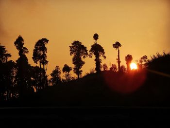 Silhouette trees against sky during sunset