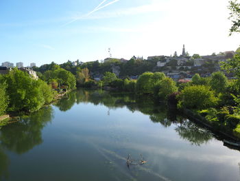 High angle view of trees by lake against sky