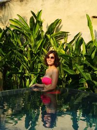 Portrait of a smiling young woman in swimming pool