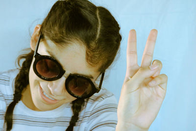 Young woman showing peace sign