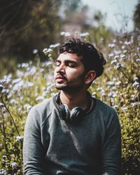 Portrait of young man looking away in forest