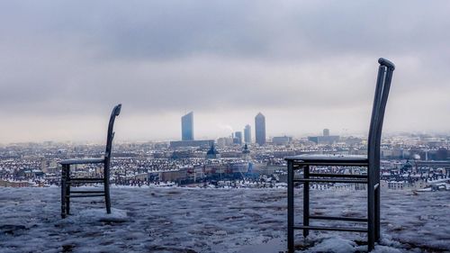 Scenic view of cityscape against sky during winter