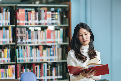 Young woman looking at book