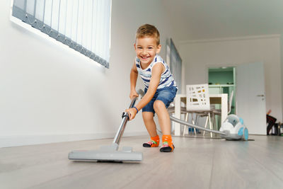 Portrait of smiling boy on floor at home