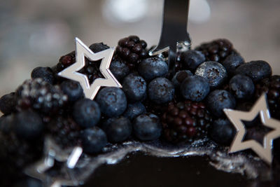 Black cake with stars and berries with the number one