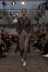 Crowd standing at illuminated market