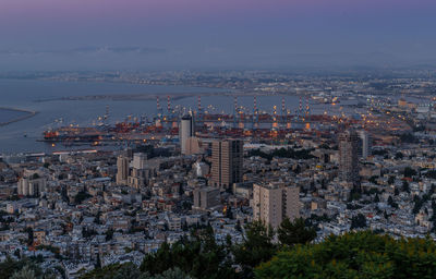 Aerial view of modern buildings in city against sky