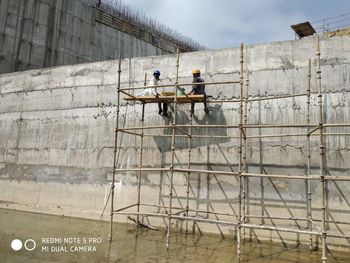 Low angle view of people working in construction site