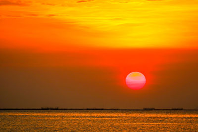 Scenic view of sea against romantic sky at sunset
