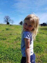 Portrait of cute girl on field