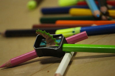 Close-up of pencils and sharpener on table