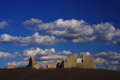 Panoramic view of old building on field against sky