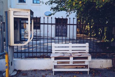 Empty chairs and tables against building in city