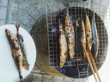 High angle view of meat on barbecue grill