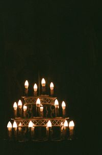 Illuminated temple against clear sky at night