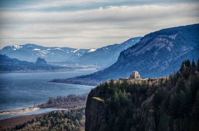 Panoramic view of buildings and mountains against sky